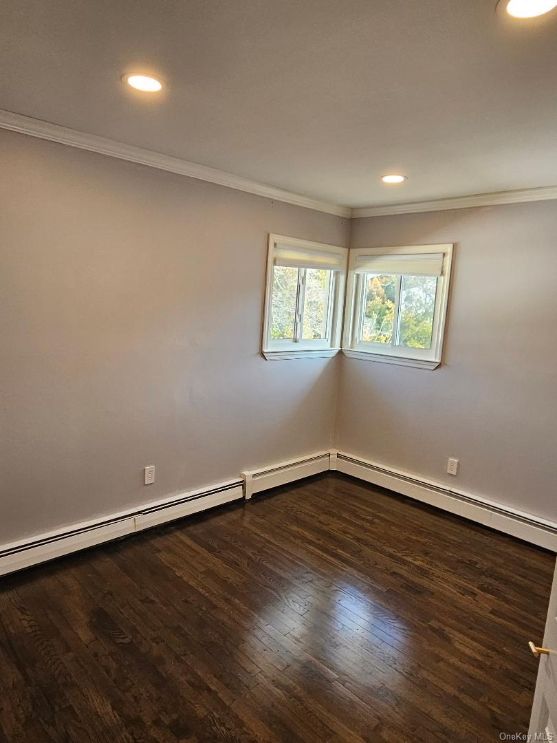 149 Truxton Road Dix Hills, NY 11746 - Photo 18 of 22 Spare room with ornamental molding, recessed lighting, dark wood-type flooring, and a baseboard radiator