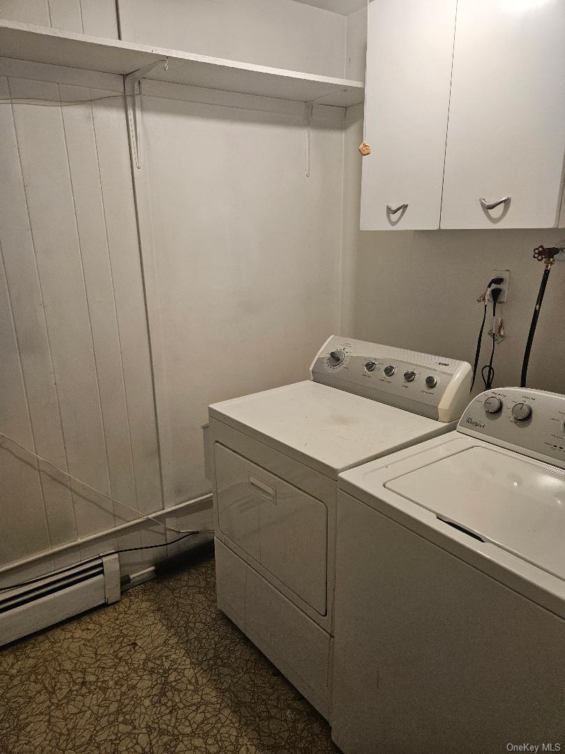 149 Truxton Road Dix Hills, NY 11746 - Photo 7 of 22 Washroom with baseboard heating, washer and dryer, cabinet space, and dark floors