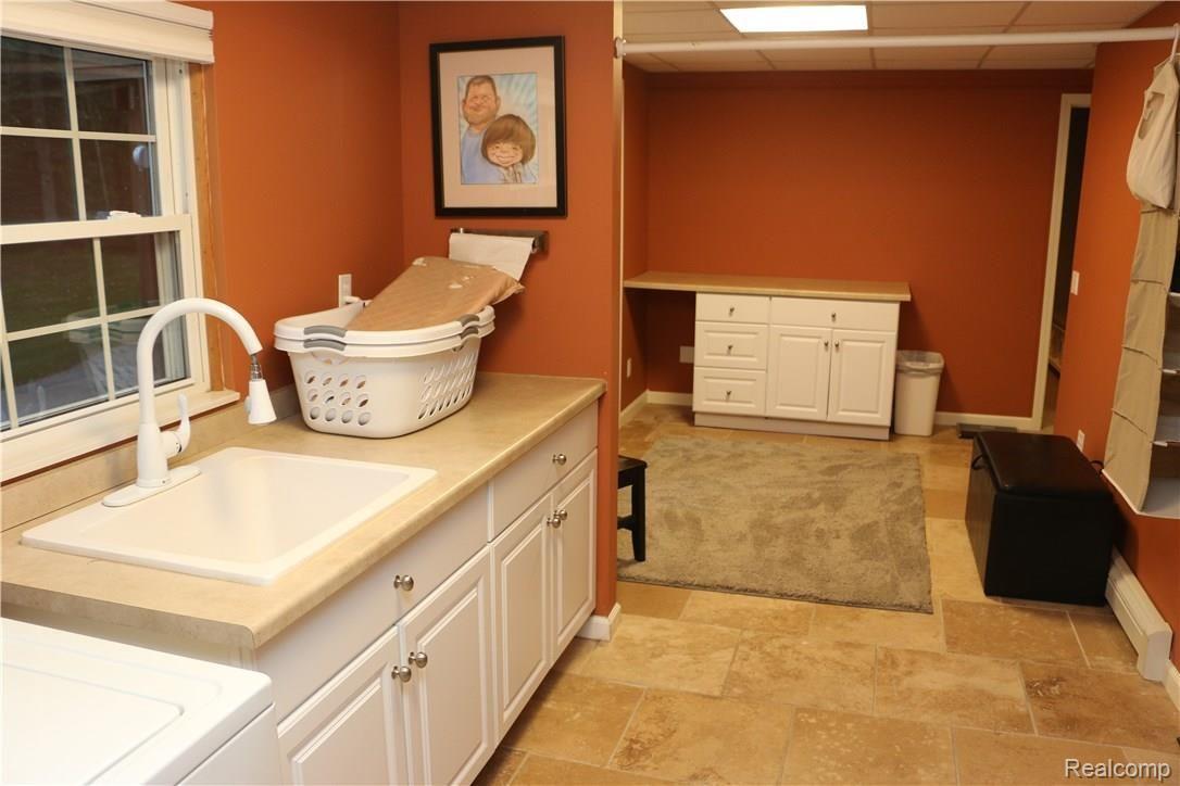 9404 Mabley Hill Road Fenton, MI 48430 - Photo 39 of 46 Other view of the laundry area from the washer/dryer perspective. Lots of room for a tv or play area for when it's laundry day.