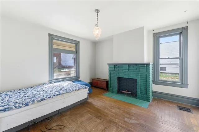 a bedroom with a bed and a fireplace