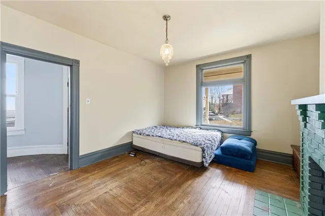 a spacious bedroom with a bed a couch and a window