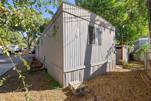 a view of a house with backyard and wooden fence