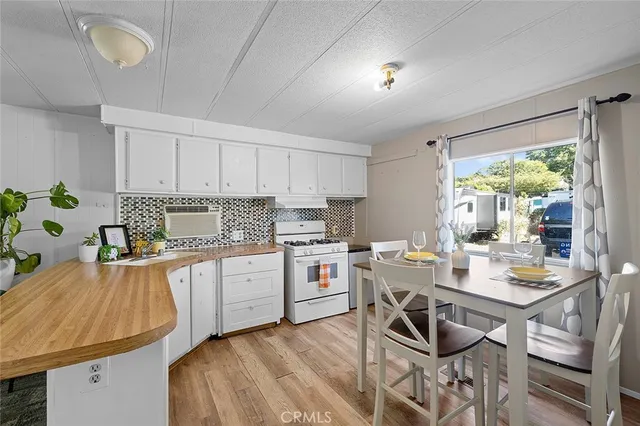 a kitchen with a sink stove and white cabinets