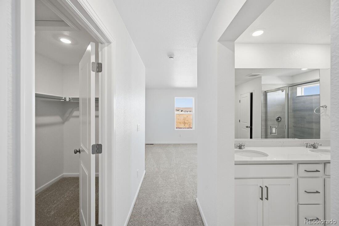 16857 West 92nd Loop Arvada, CO 80007 - Photo 16 of 31 a bathroom with a sink and a mirror