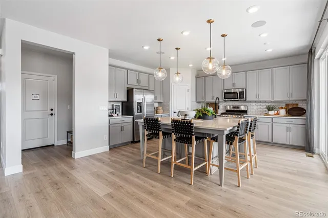 a kitchen with stainless steel appliances granite countertop a stove and a sink