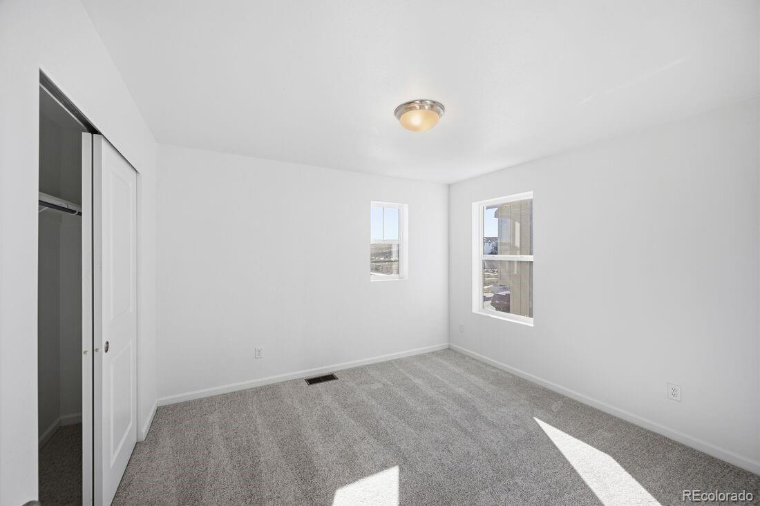 16857 West 92nd Loop Arvada, CO 80007 - Photo 19 of 31 an empty room with windows