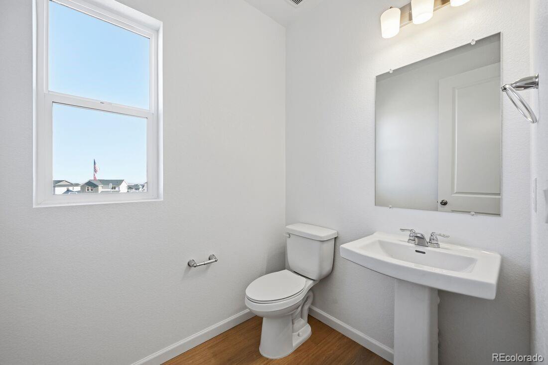 16857 West 92nd Loop Arvada, CO 80007 - Photo 23 of 31 a bathroom with a sink toilet and mirror