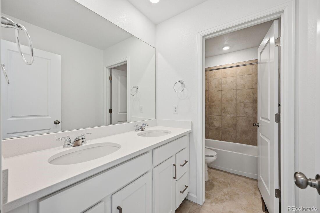 16857 West 92nd Loop Arvada, CO 80007 - Photo 24 of 31 a bathroom with a sink a shower and a mirror