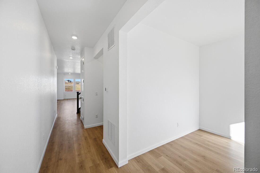 16857 West 92nd Loop Arvada, CO 80007 - Photo 9 of 31 a view of hallway with wooden floor