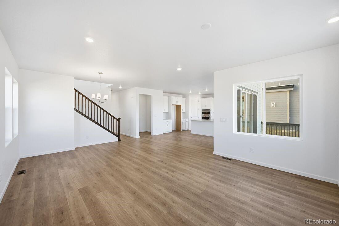 16857 West 92nd Loop Arvada, CO 80007 - Photo 10 of 31 a view of an empty room with wooden floor and a window