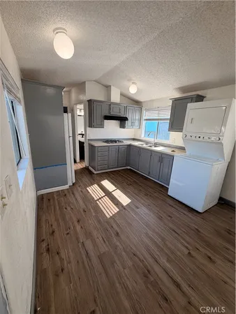 a kitchen with stainless steel appliances wooden floors and wooden cabinets