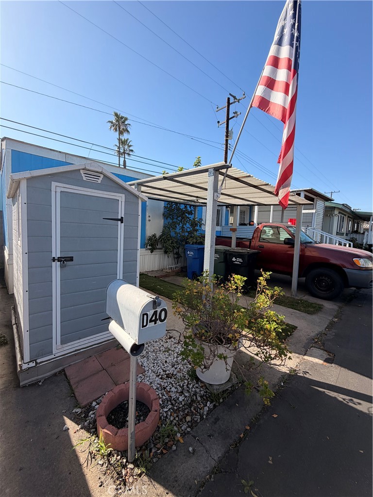 16511 Garfield Avenue, Unit D40 Paramount, CA 90723 - Photo 15 of 18 a front view of a house with a yard