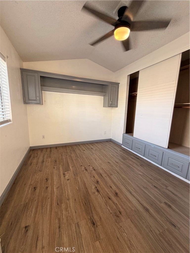 16511 Garfield Avenue, Unit D40 Paramount, CA 90723 - Photo 8 of 18 a view of an empty room with wooden floor and a window