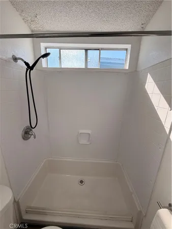 a bathroom with a shower and tub