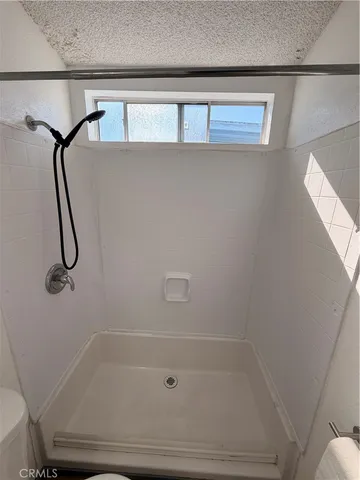a bathroom with a shower and tub