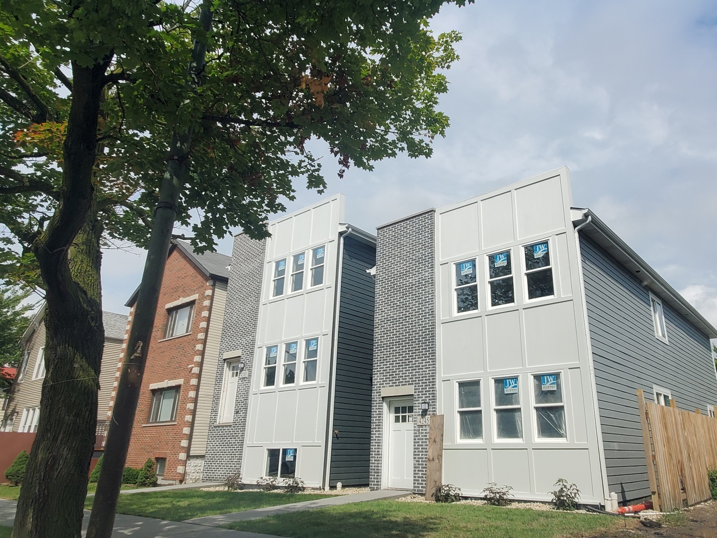 a front view of a building with a garden