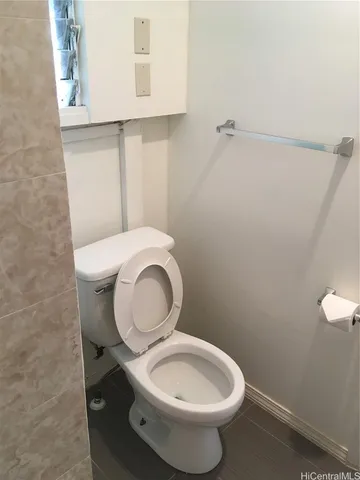 a white toilet sitting next to a bathroom sink