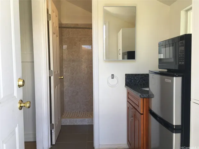 a kitchen with a refrigerator and a stove top oven