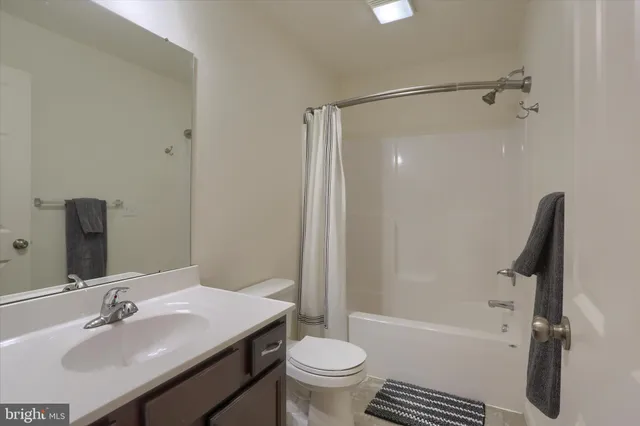 a bathroom with a sink toilet tub and shower