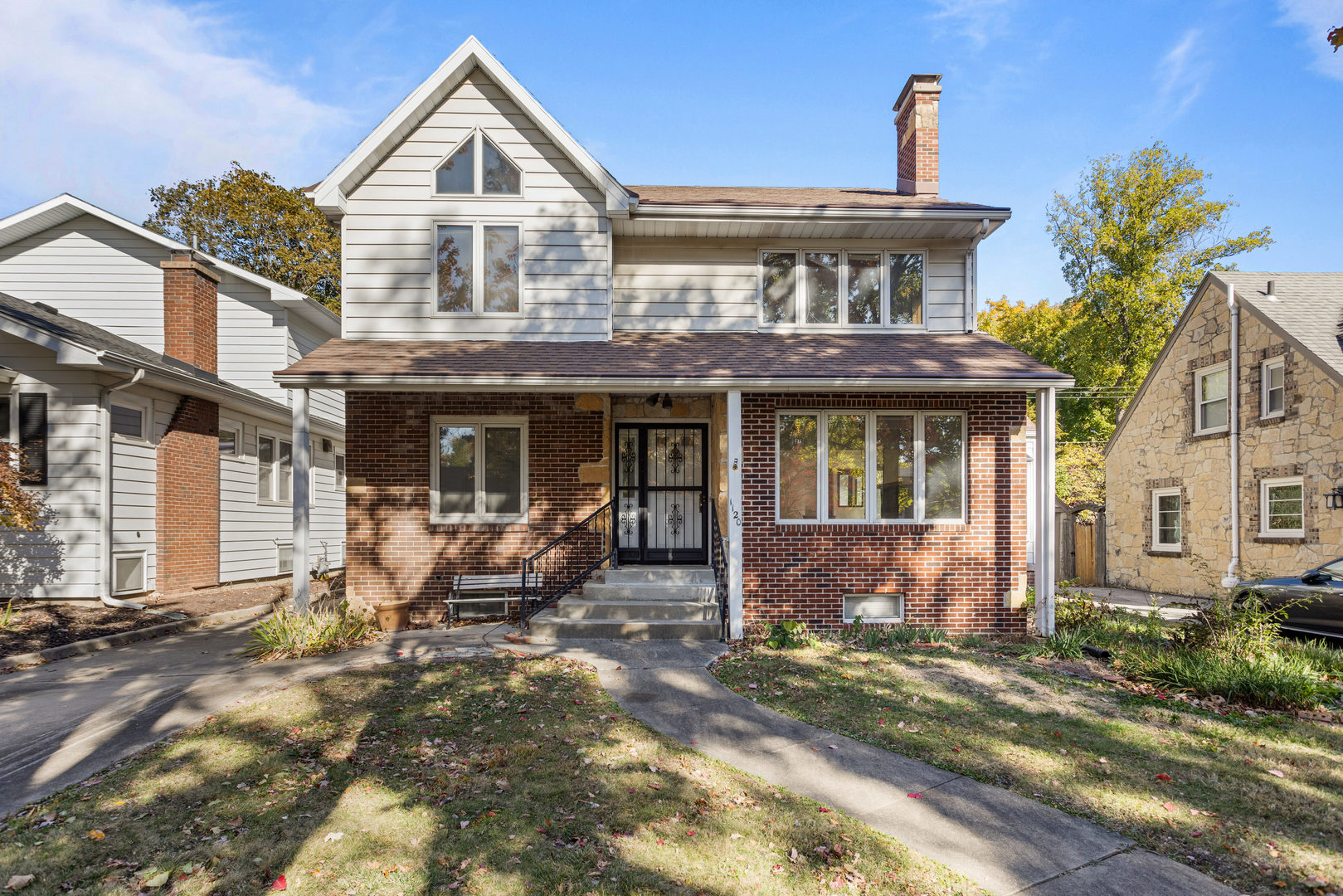 a front view of a house with yard and green space
