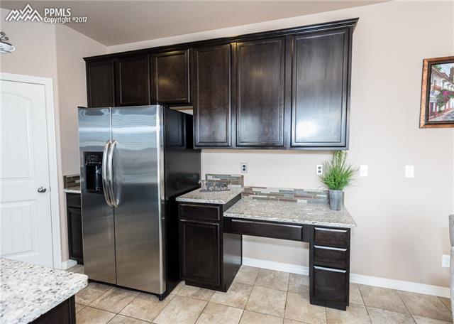 2105 Reed Grass Way Colorado Springs, CO 80915 - Photo 8 of 23 Kitchen includes a nice desk/ life command area, or a perfect coffee nook!