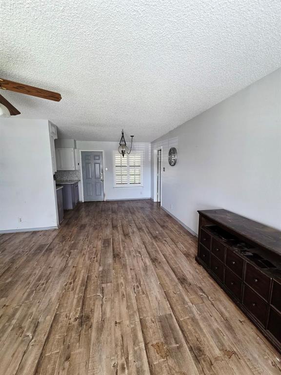 722 South Church Street Pilot Point, TX 76258 - Photo 9 of 37 a view of empty room with wooden floor and fan