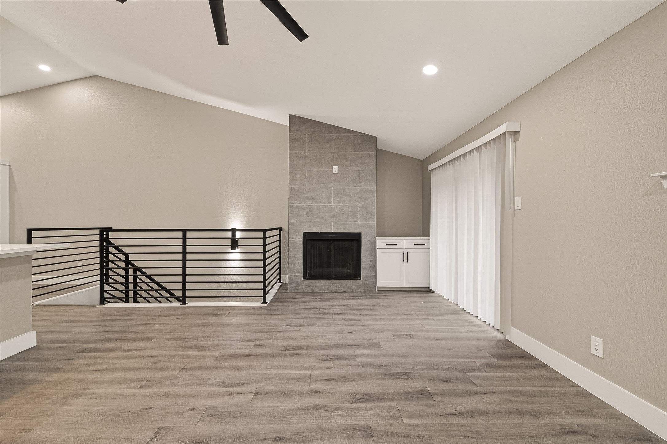 6750 Sands Point Drive Houston, TX 77074 - Photo 12 of 39 Oversize living area with ceramic tile wrapped wood burning fireplace.