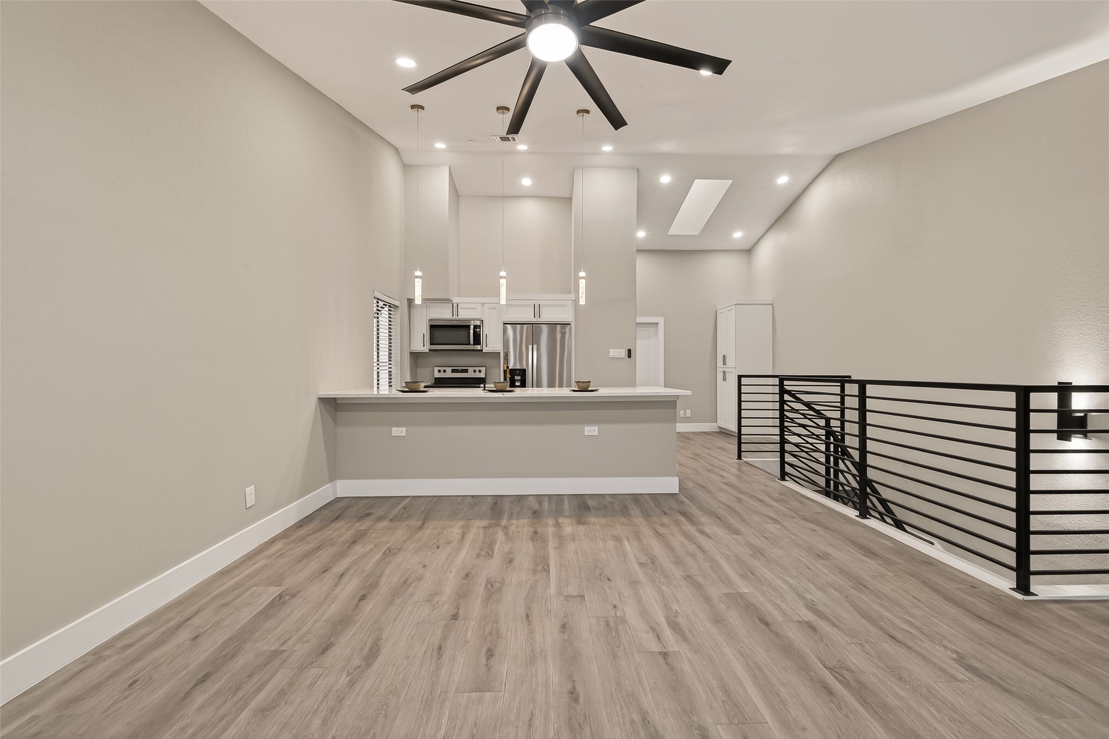 6750 Sands Point Drive Houston, TX 77074 - Photo 15 of 39 a view of a kitchen with kitchen island a sink wooden floor stainless steel appliances and a window