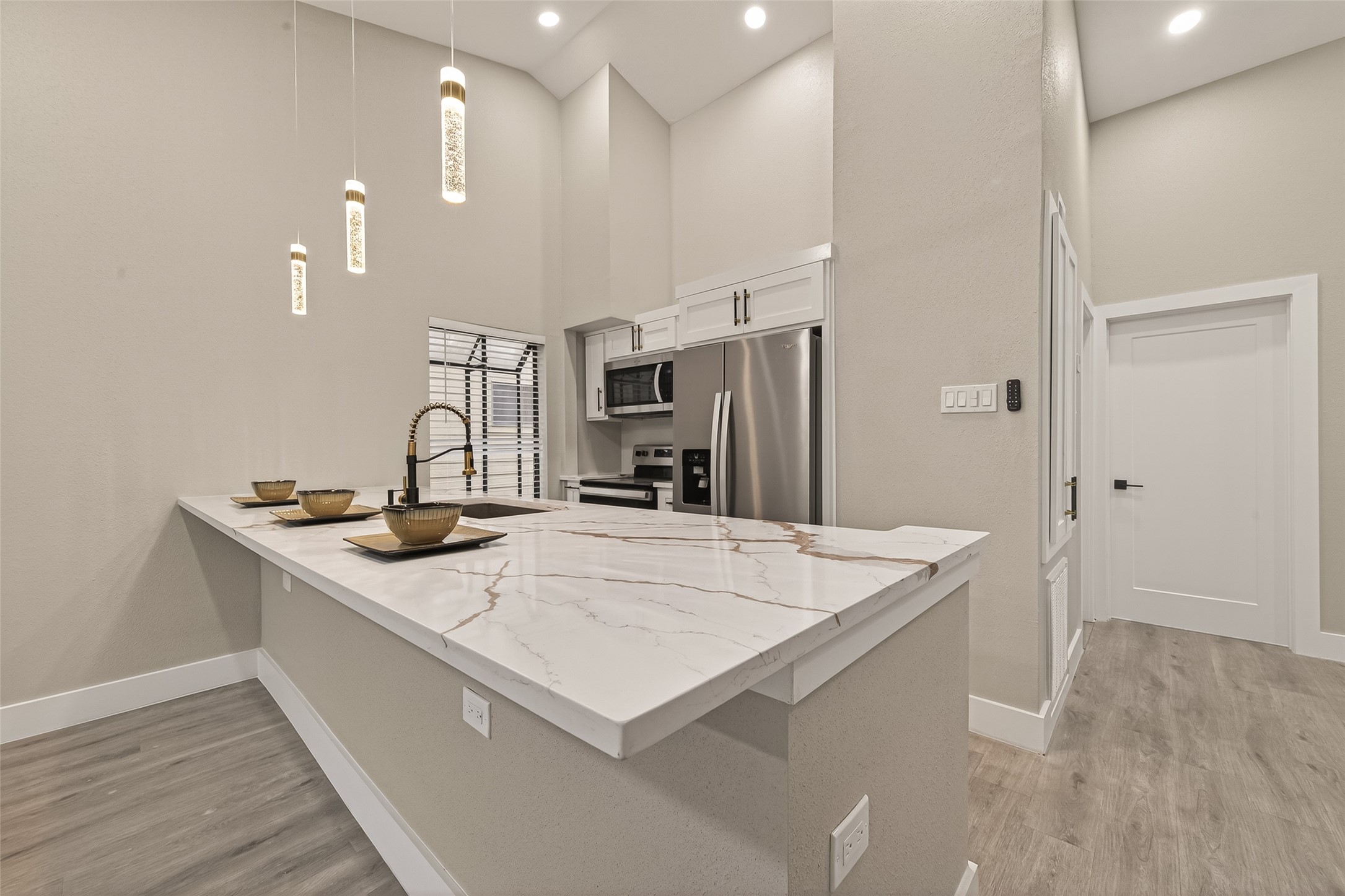 6750 Sands Point Drive Houston, TX 77074 - Photo 18 of 39 a room with kitchen island a sink and wooden floor