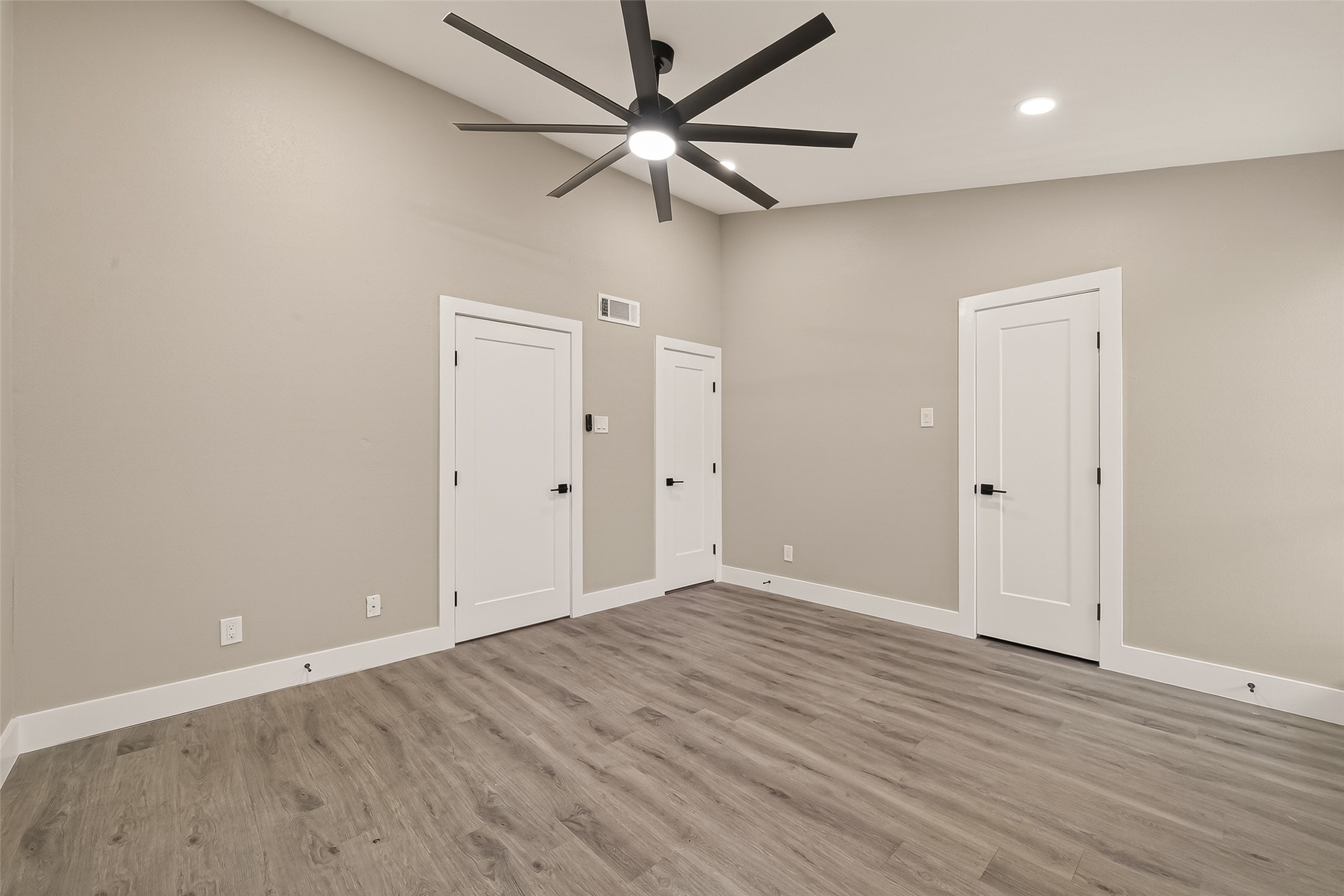 6750 Sands Point Drive Houston, TX 77074 - Photo 24 of 39 an empty room with wooden floor ceiling fan and windows