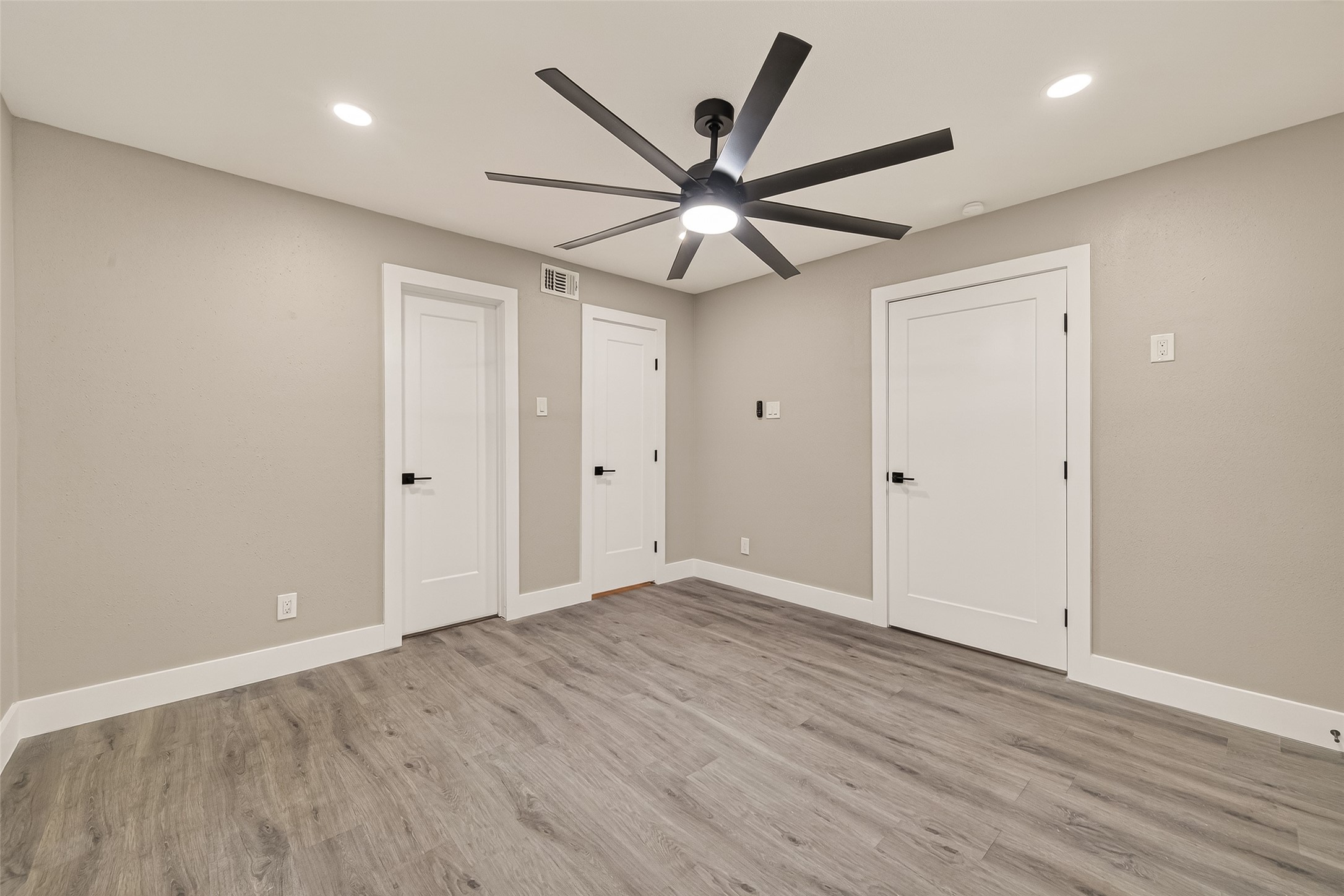 6750 Sands Point Drive Houston, TX 77074 - Photo 25 of 39 an empty room with wooden floor ceiling fan and windows
