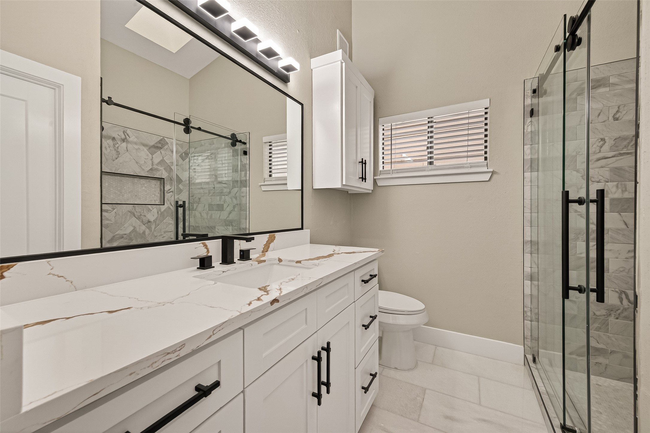 6750 Sands Point Drive Houston, TX 77074 - Photo 29 of 39 a bathroom with a sink a toilet a mirror and shower