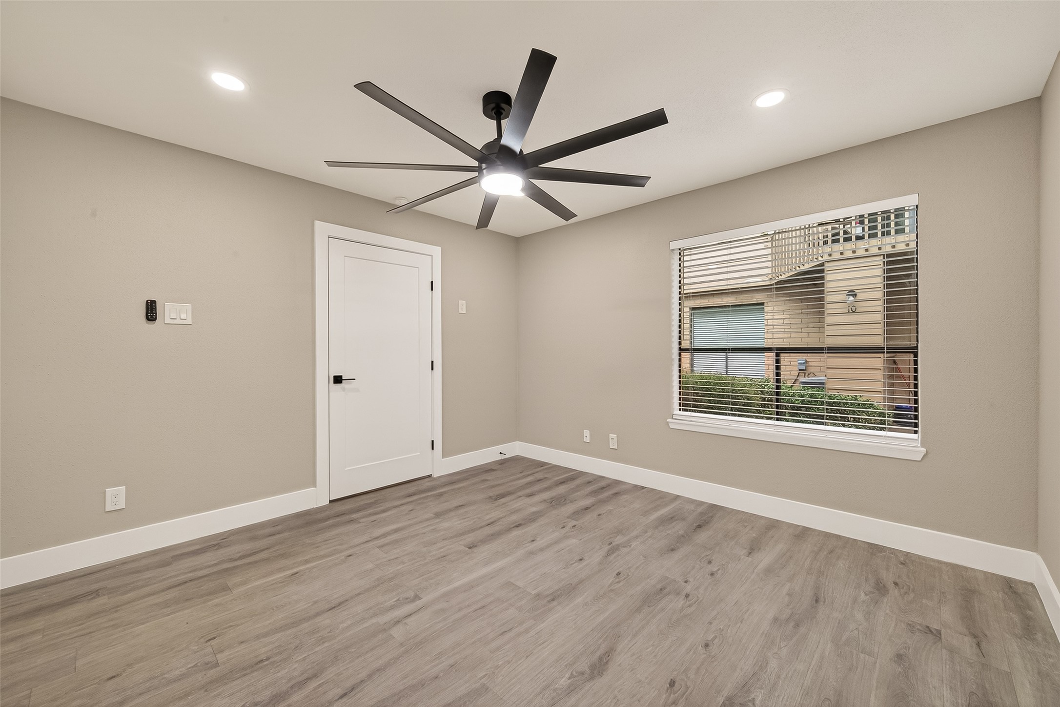 6750 Sands Point Drive Houston, TX 77074 - Photo 7 of 39 Light filled secondary bedroom featuring a modern remote controlled ceiling fan and recessed lights.