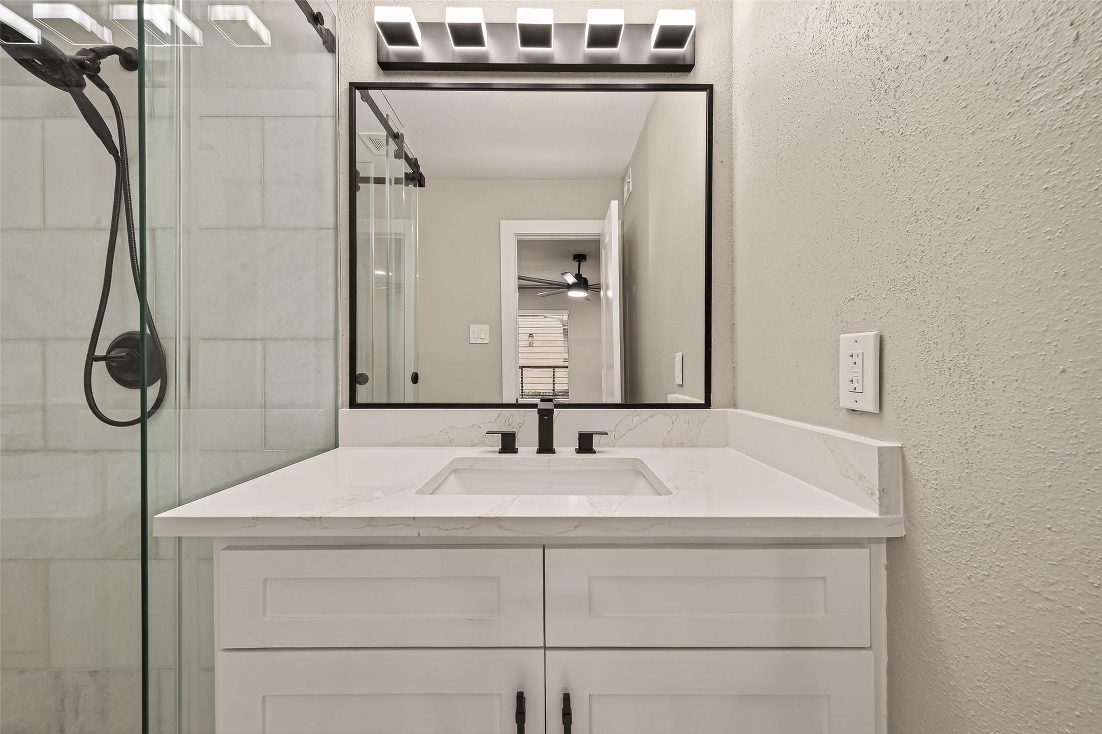 6750 Sands Point Drive Houston, TX 77074 - Photo 10 of 39 Spacious bath quartz countertop, framed mirror and modern light fixture.