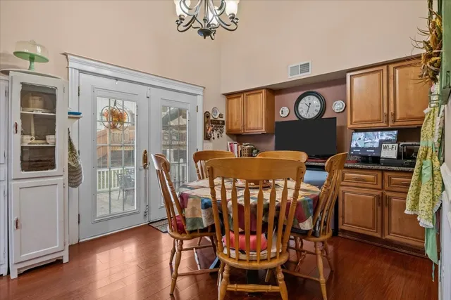 a dining room with furniture a window and wooden floor