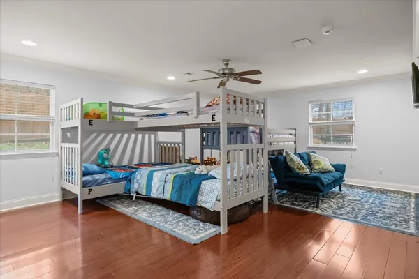 a bedroom with furniture and a wooden floor