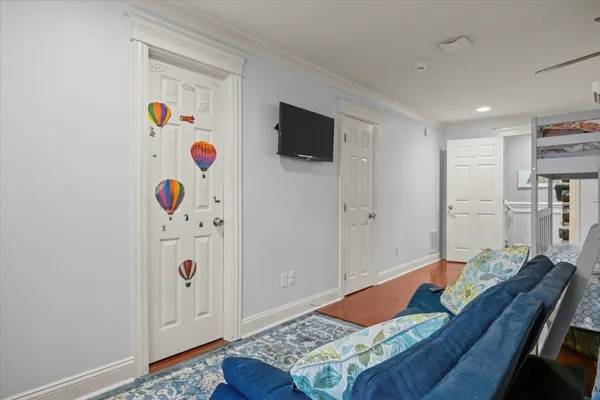 a living room with kitchen island furniture and a wooden floor