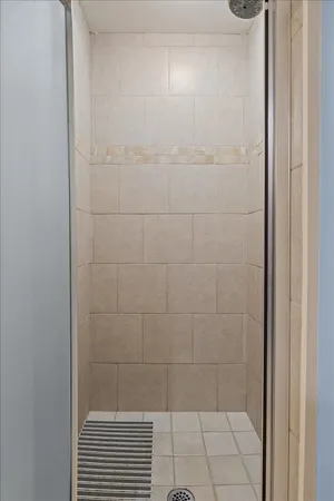 a view of a patio with a dining table and chairs with wooden floor and fence