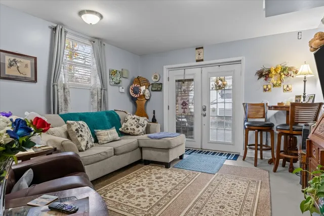 a kitchen with appliances a table and chairs in it