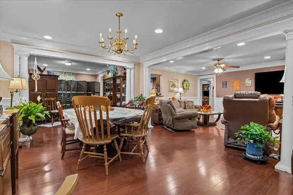 a view of a dining room with furniture wooden floor and chandelier