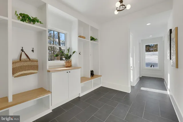 a kitchen with a stove a refrigerator and a dining table with wooden floor