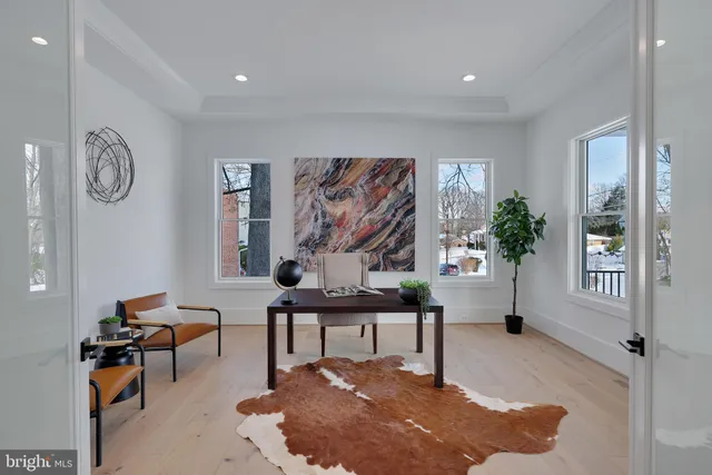 a view of a hallway with wooden floor and entryway
