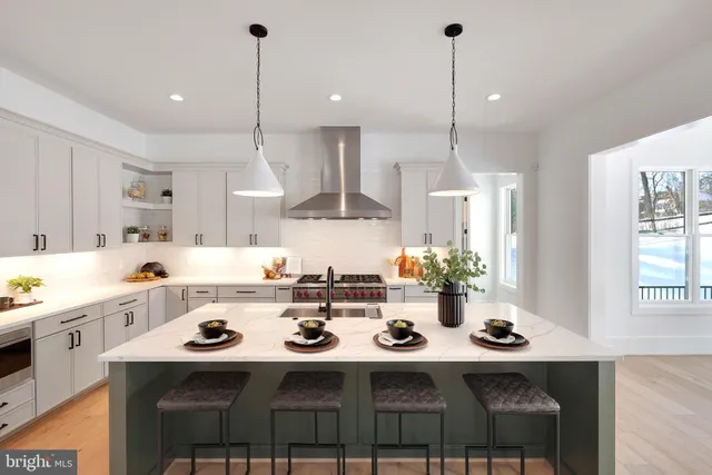 a living room with furniture a fireplace and a chandelier