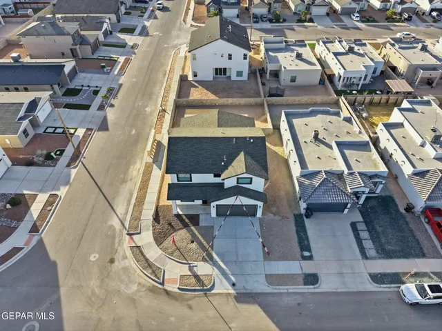a kitchen with a sink a refrigerator and a stove top oven