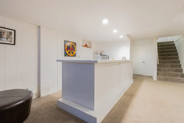 a view of kitchen with stainless steel appliances cabinets and wooden floor