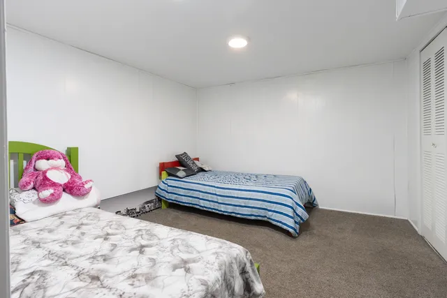 a bedroom with two bed and painted walls