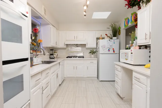 a kitchen with cabinets and white appliances