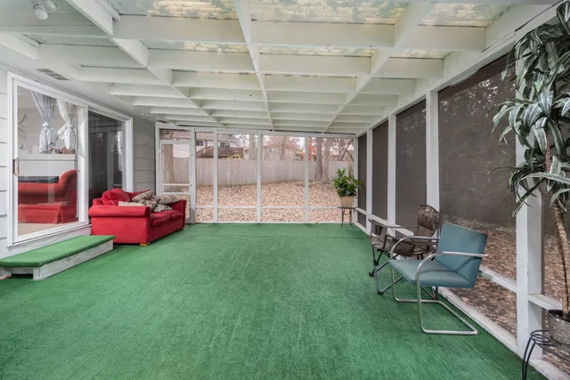 a view of a chairs in backyard of house