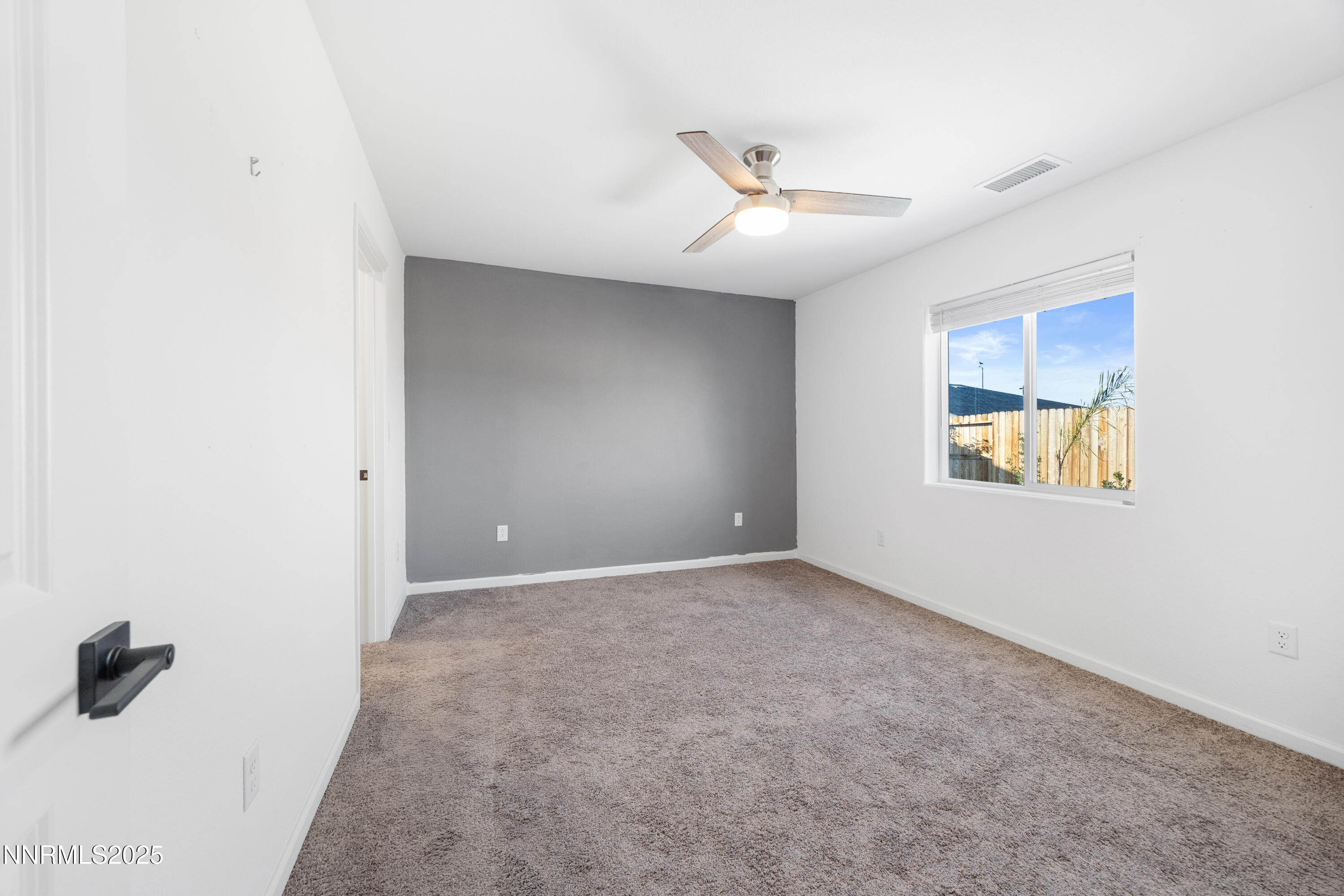 737 Valmy Drive Reno, NV 89506 - Photo 11 of 14 an empty room with windows and fan