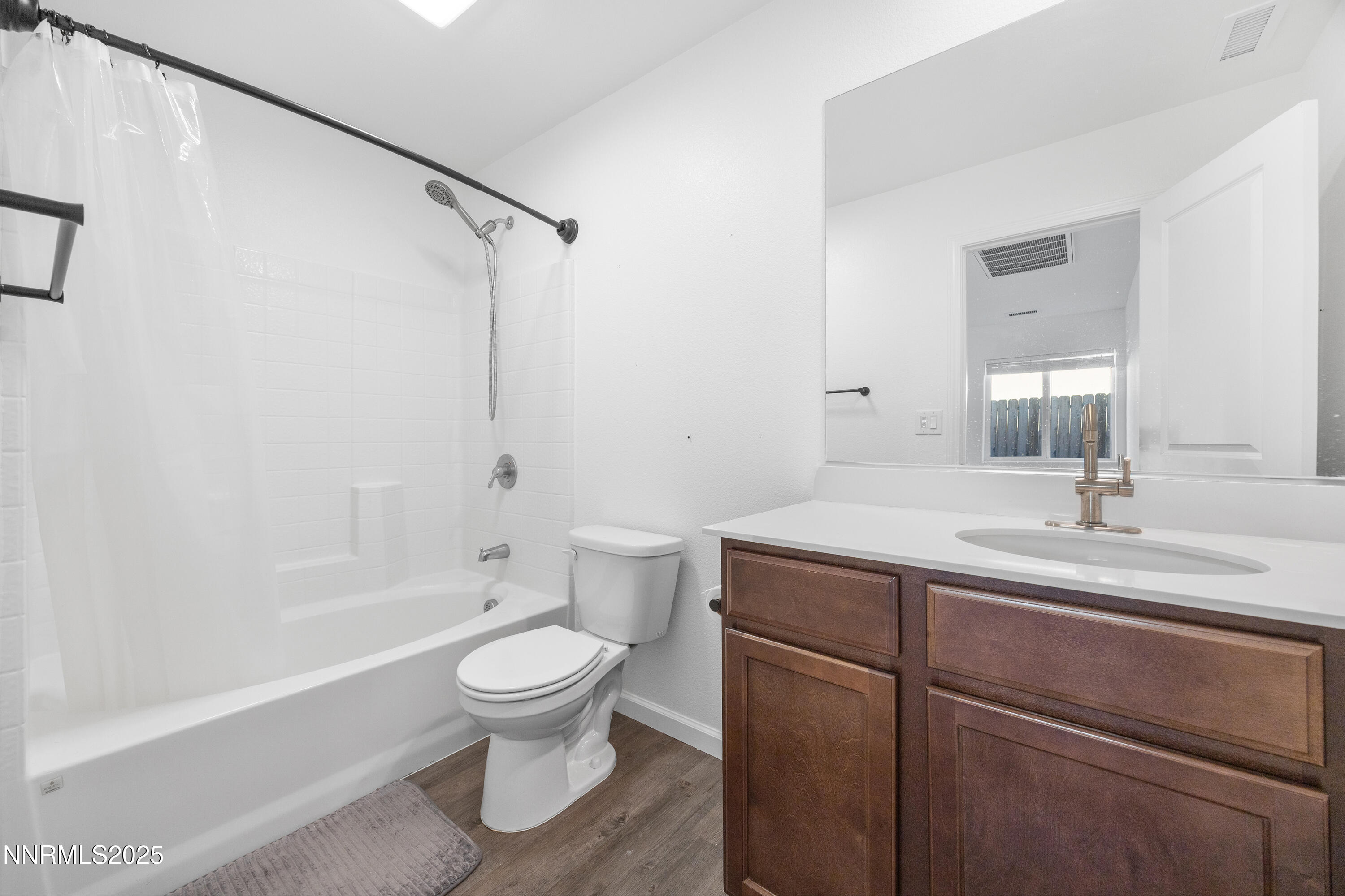737 Valmy Drive Reno, NV 89506 - Photo 6 of 14 a bathroom with a granite countertop toilet a sink and a bathtub